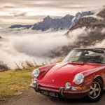 Classic Porsche 911 parked in front of mountains