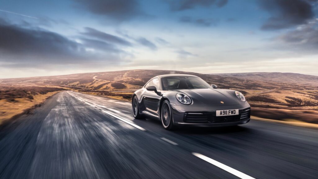 Modern Porsche 911 Turbo S speeding on highway